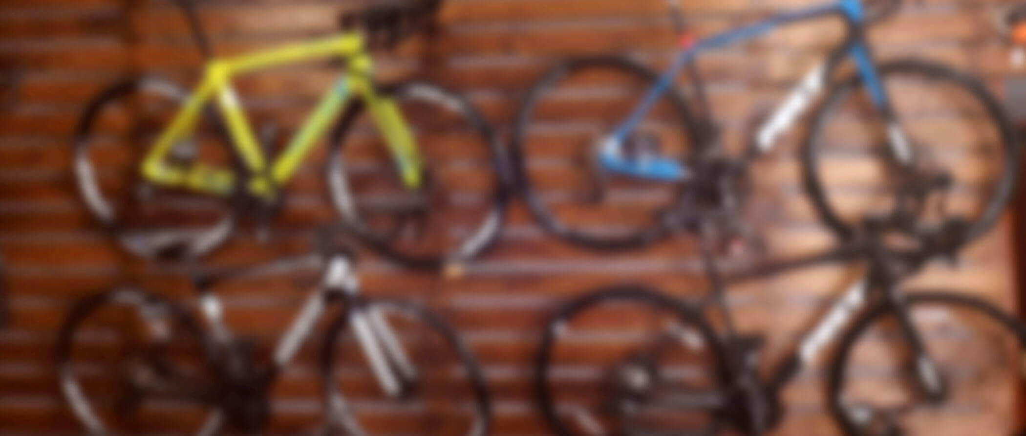 A blurry view of a bicycle rental store with bikes mounted on the wall.